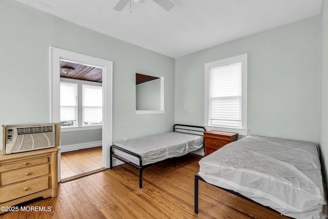 1103 A St, Belmar, NJ 07719 - bedroom with hardwood / wood-style flooring, an AC wall unit, and ceiling fan