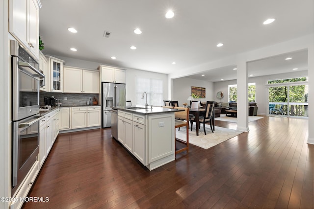 11 Starboard Ct, Little Egg Harbor, NJ 08087 - kitchen featuring stainless steel appliances, dark countertops, open floor plan, backsplash, and a breakfast bar