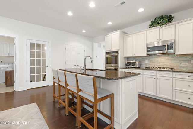 11 Starboard Ct, Little Egg Harbor, NJ 08087 - kitchen with stainless steel appliances, washer / clothes dryer, dark wood finished floors, decorative backsplash, and recessed lighting