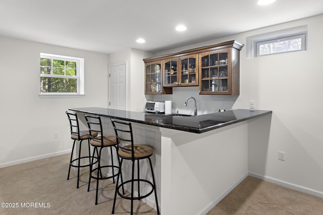 11 Starboard Ct, Little Egg Harbor, NJ 08087 - kitchen with a kitchen breakfast bar, light colored carpet, glass insert cabinets, a peninsula, and recessed lighting
