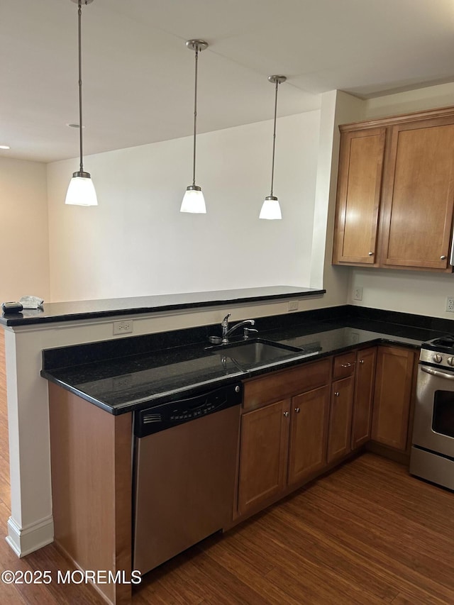 2346 Rte 33 Unit 205, Robbinsville, NJ 08691 - kitchen with appliances with stainless steel finishes, dark wood finished floors, pendant lighting, a peninsula, and brown cabinets