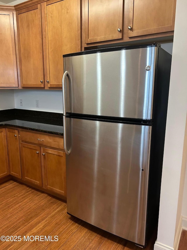 2346 Rte 33 Unit 205, Robbinsville, NJ 08691 - kitchen featuring freestanding refrigerator, light wood-type flooring, and brown cabinetry