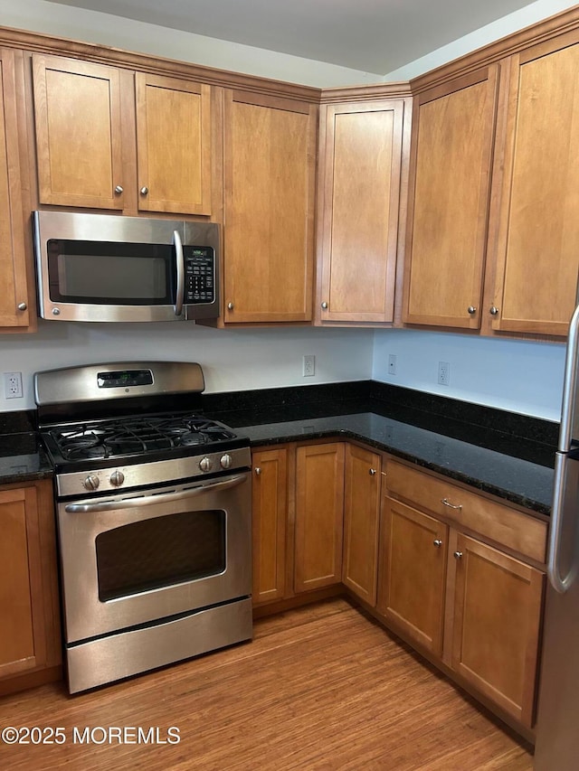 2346 Rte 33 Unit 205, Robbinsville, NJ 08691 - kitchen featuring appliances with stainless steel finishes and brown cabinets