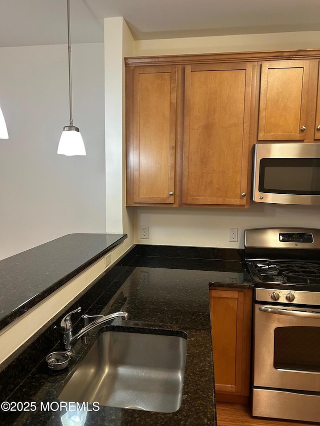 2346 Rte 33 Unit 205, Robbinsville, NJ 08691 - kitchen with stainless steel appliances, brown cabinets, and dark stone countertops