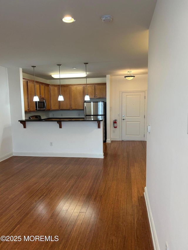 2346 Rte 33 Unit 205, Robbinsville, NJ 08691 - kitchen featuring stainless steel appliances, dark countertops, dark wood-type flooring, brown cabinetry, and recessed lighting