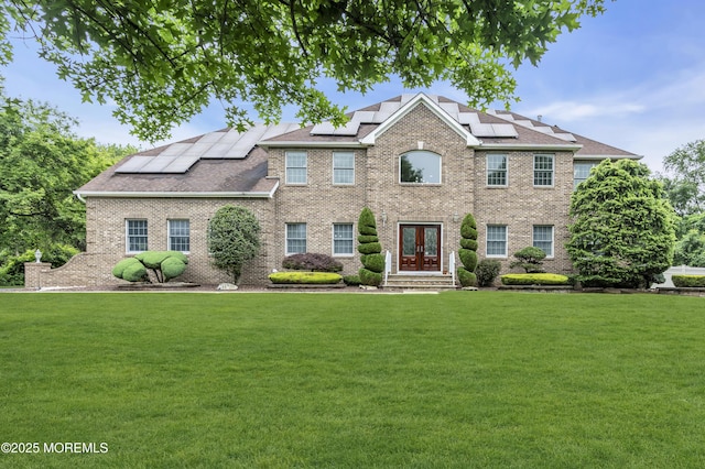 2 Michaels Ct, Jackson, NJ 08527 - view of front of property with french doors, a front lawn, brick siding, and roof mounted solar panels