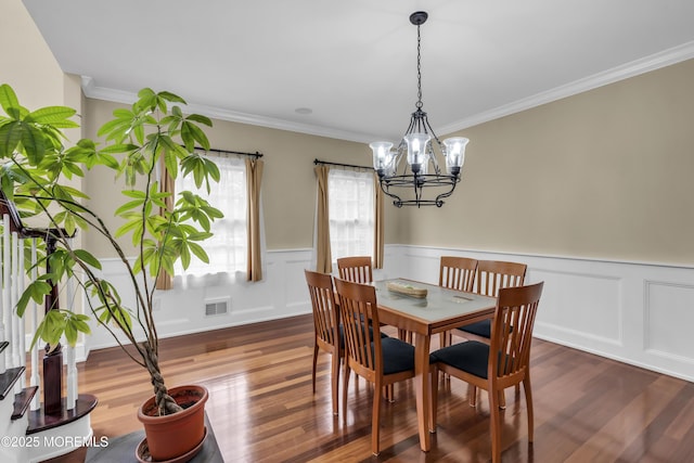 2 Michaels Ct, Jackson, NJ 08527 - dining space featuring dark wood finished floors, a chandelier, crown molding, and wainscoting