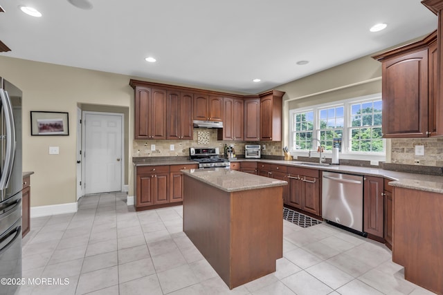 2 Michaels Ct, Jackson, NJ 08527 - kitchen with stainless steel appliances, tasteful backsplash, under cabinet range hood, light stone counters, and light tile patterned flooring