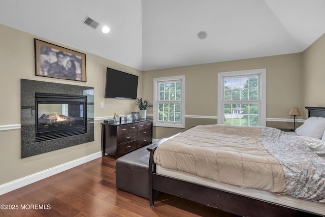 2 Michaels Ct, Jackson, NJ 08527 - bedroom with vaulted ceiling, dark wood-style floors, and a multi sided fireplace