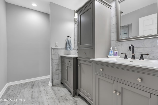2 Michaels Ct, Jackson, NJ 08527 - bathroom with two vanities, tile walls, wood finished floors, and recessed lighting