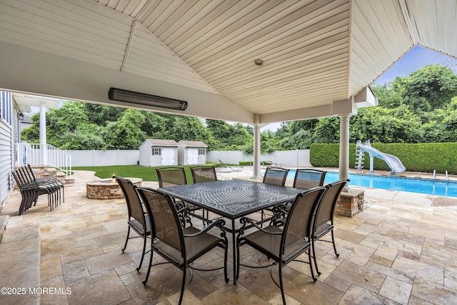 2 Michaels Ct, Jackson, NJ 08527 - fenced backyard featuring an outdoor fire pit, a shed, a patio area, and view of wooded area