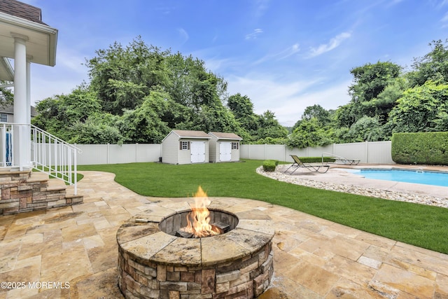 2 Michaels Ct, Jackson, NJ 08527 - fenced backyard featuring a fire pit, a patio, a storage shed, and view of scattered trees