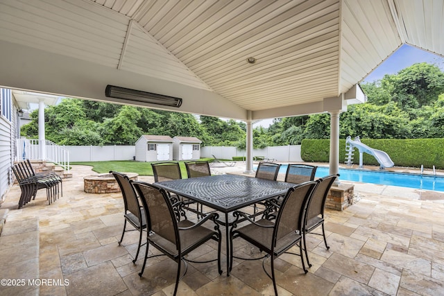 2 Michaels Ct, Jackson, NJ 08527 - fenced backyard with a storage shed, a patio area, an outdoor fire pit, view of scattered trees, and outdoor dining area