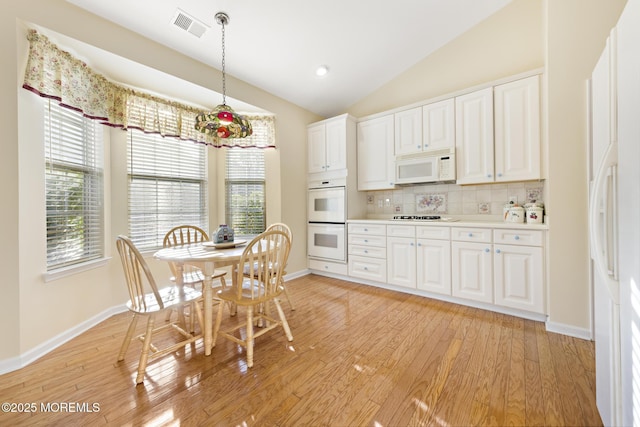 105 Golf View Dr, Little Egg Harbor, NJ 08087 - kitchen with white appliances, tasteful backsplash, white cabinetry, light wood finished floors, and lofted ceiling