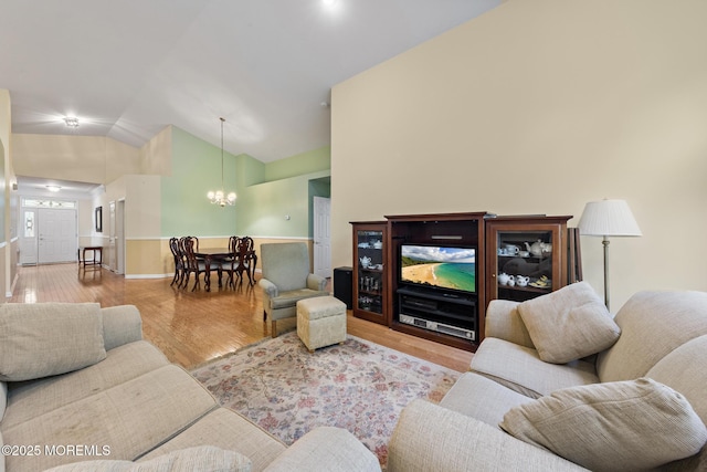 105 Golf View Dr, Little Egg Harbor, NJ 08087 - living room featuring a chandelier, vaulted ceiling, and wood finished floors