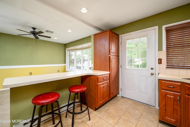 1161B Argyll Cir, Lakewood, NJ 08701 - kitchen with a peninsula, a kitchen breakfast bar, recessed lighting, ceiling fan, and light tile patterned floors