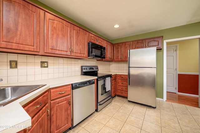1161B Argyll Cir, Lakewood, NJ 08701 - kitchen featuring appliances with stainless steel finishes, recessed lighting, light countertops, decorative backsplash, and light tile patterned floors