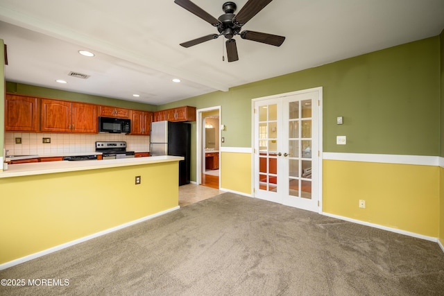 1161B Argyll Cir, Lakewood, NJ 08701 - kitchen featuring electric range oven, black microwave, french doors, freestanding refrigerator, and light carpet