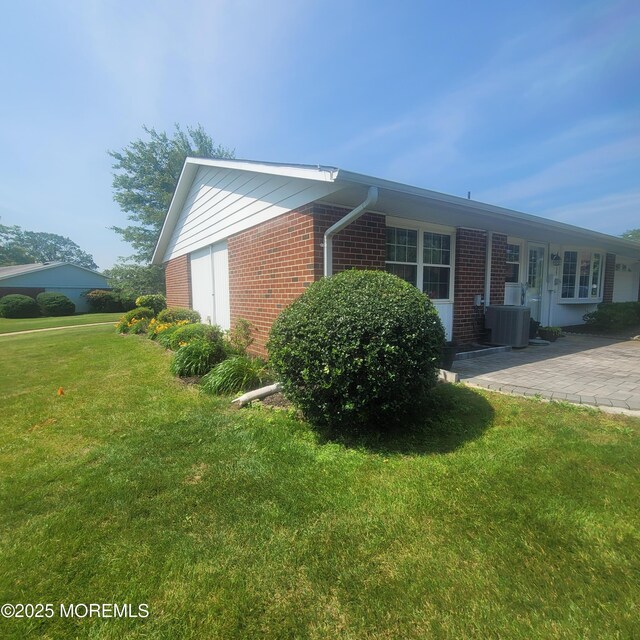 1161B Argyll Cir, Lakewood, NJ 08701 - view of property exterior featuring brick siding, a yard, and a patio