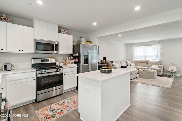 404 Cyprus Ct, Forked River, NJ 08731 - kitchen featuring appliances with stainless steel finishes, white cabinets, open floor plan, light countertops, and a kitchen island