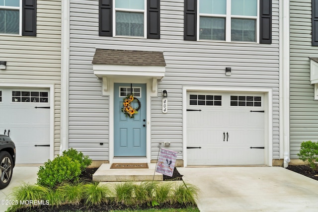 404 Cyprus Ct, Forked River, NJ 08731 - property entrance featuring a garage, driveway, and a shingled roof