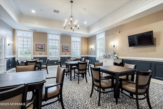 6 Cameron Ct, Forked River, NJ 08731 - dining space with a wainscoted wall, crown molding, a chandelier, a raised ceiling, and a decorative wall