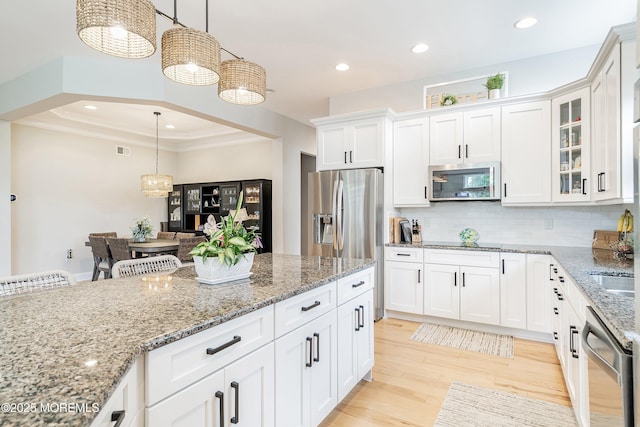 6 Cameron Ct, Forked River, NJ 08731 - kitchen with appliances with stainless steel finishes, white cabinetry, light wood-type flooring, light stone countertops, and pendant lighting