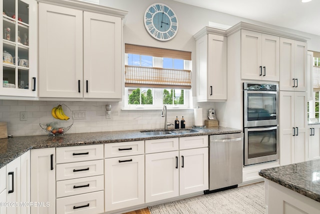 6 Cameron Ct, Forked River, NJ 08731 - kitchen featuring stainless steel appliances, backsplash, dark stone counters, glass insert cabinets, and white cabinets