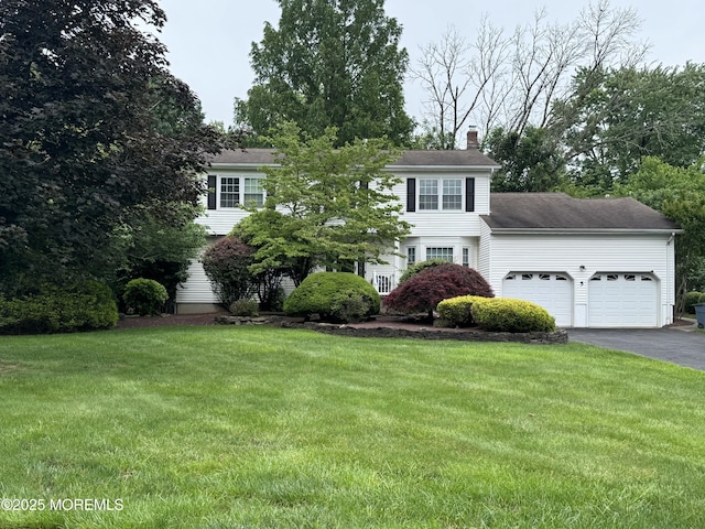 5 Foxboro Ln, Manalapan, NJ 07726 - view of front of home featuring an attached garage, a chimney, driveway, and a front lawn