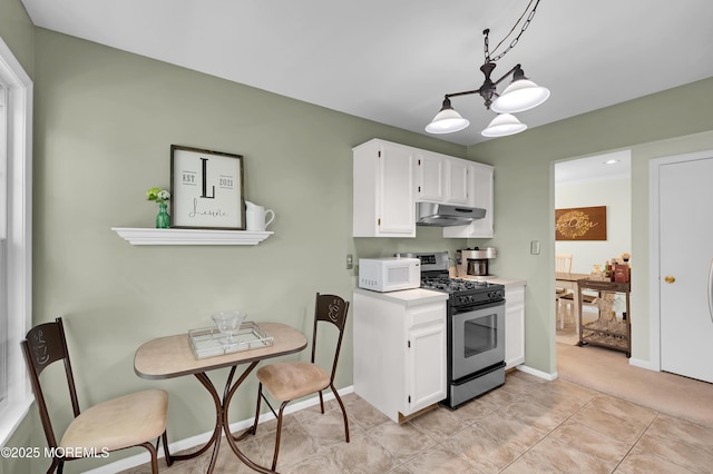 54 Chinkaberry Ct, Howell, NJ 07731 - kitchen featuring stainless steel range with gas cooktop, white microwave, under cabinet range hood, white cabinets, and light countertops