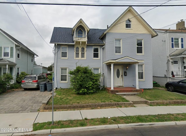 40 Church St, Keyport, NJ 07735 - victorian house featuring a front yard, driveway, and roof with shingles