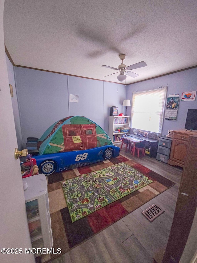 9 Casey Ct, Barnegat, NJ 08005 - game room featuring wood finished floors, a ceiling fan, and a textured ceiling