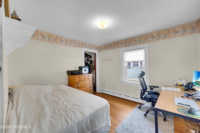 18 Slocum St, West Long Branch, NJ 07764 - bedroom featuring a baseboard heating unit, wood finished floors, and a desk