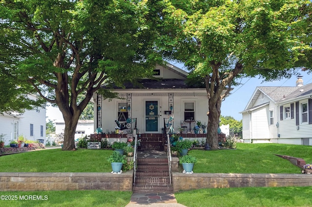 18 Slocum St, West Long Branch, NJ 07764 - view of front of house with covered porch, a front lawn, and stucco siding