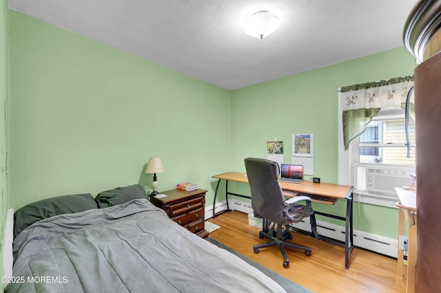 18 Slocum St, West Long Branch, NJ 07764 - bedroom featuring wood finished floors, cooling unit, a baseboard radiator, and a desk