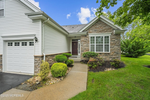 160 Kyle Ct Unit 160, Monroe, NJ 08831 - view of front of home with stone siding, a front lawn, asphalt driveway, and an attached garage