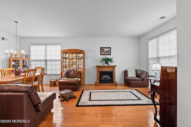 160 Kyle Ct Unit 160, Monroe, NJ 08831 - living area with a chandelier, a fireplace, and wood finished floors