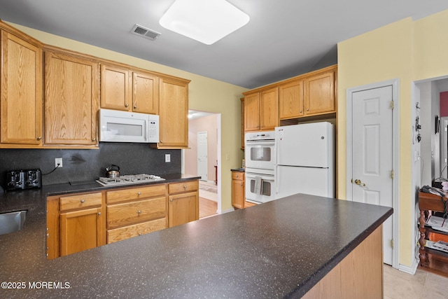160 Kyle Ct Unit 160, Monroe, NJ 08831 - kitchen with white appliances, dark countertops, and light tile patterned floors