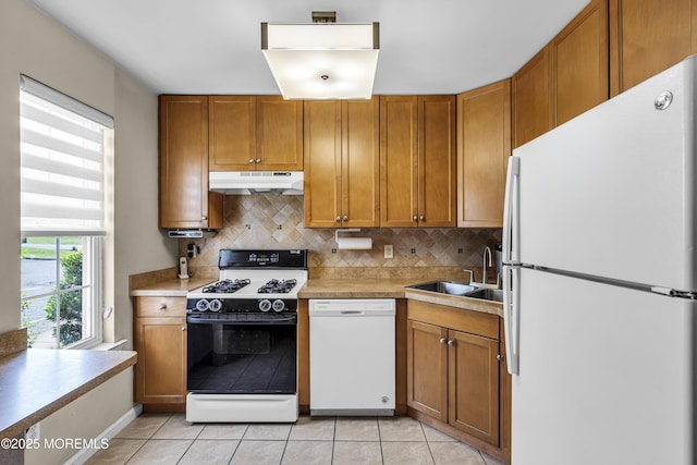 106 Aspen Ct, Lakewood, NJ 08701 - kitchen with white appliances, under cabinet range hood, light countertops, brown cabinets, and light tile patterned flooring