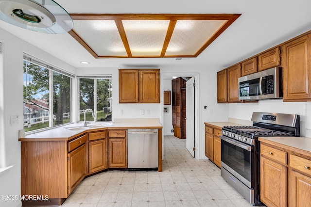 1091A Canterbury Dr, Manchester, NJ 08759 - kitchen featuring stainless steel appliances, light countertops, and brown cabinets