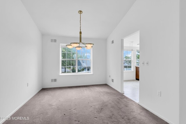 1091A Canterbury Dr, Manchester, NJ 08759 - carpeted empty room featuring a chandelier and baseboards