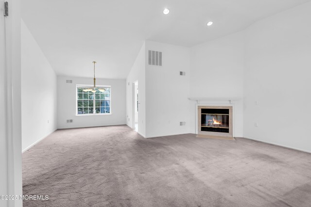 1091A Canterbury Dr, Manchester, NJ 08759 - unfurnished living room featuring a fireplace with flush hearth, carpet flooring, a chandelier, recessed lighting, and high vaulted ceiling