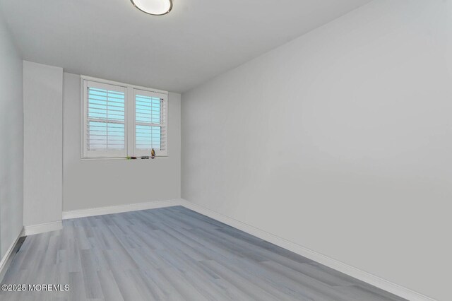 675 Ocean Ave Unit 5J, Long Branch, NJ 07740 - empty room featuring wood finished floors and baseboards
