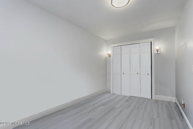675 Ocean Ave Unit 5J, Long Branch, NJ 07740 - unfurnished bedroom featuring light wood-style floors and a closet