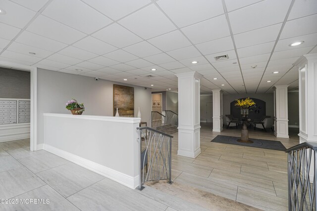675 Ocean Ave Unit 5J, Long Branch, NJ 07740 - corridor with decorative columns, an upstairs landing, recessed lighting, and a drop ceiling