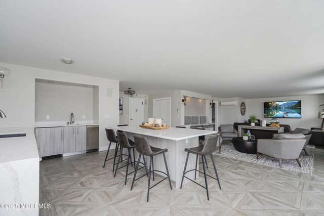 675 Ocean Ave Unit 5J, Long Branch, NJ 07740 - kitchen featuring a kitchen bar, light countertops, a center island, open floor plan, and an AC wall unit