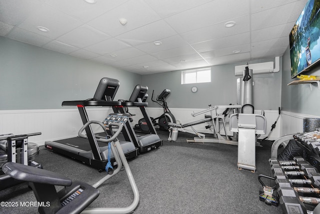 675 Ocean Ave Unit 5J, Long Branch, NJ 07740 - gym featuring a wainscoted wall, a paneled ceiling, and a wall mounted air conditioner