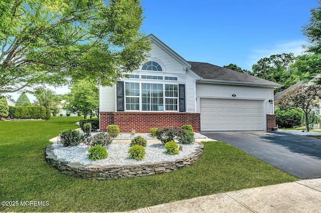 31 Orleans Dr, Manchester, NJ 08759 - view of front facade with brick siding, driveway, a front lawn, and an attached garage