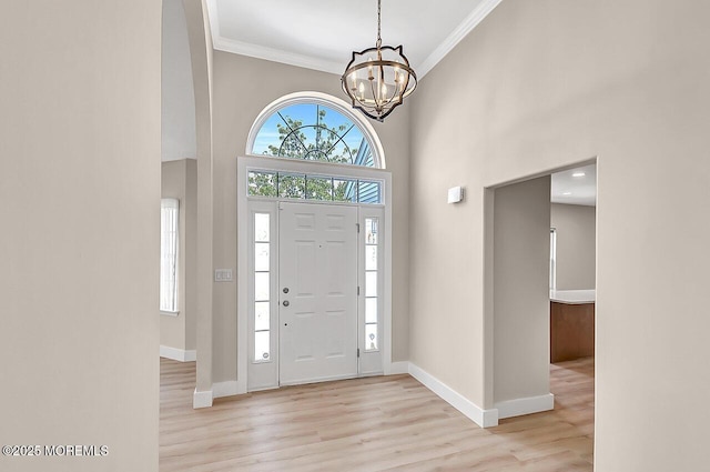 31 Orleans Dr, Manchester, NJ 08759 - entrance foyer with light wood-style floors, ornamental molding, a chandelier, and a towering ceiling