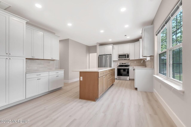 31 Orleans Dr, Manchester, NJ 08759 - kitchen with appliances with stainless steel finishes, recessed lighting, light wood finished floors, a center island, and tasteful backsplash
